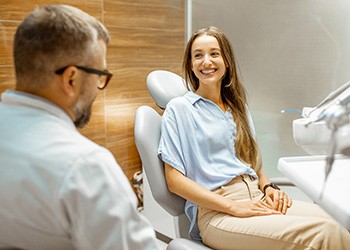 Female patient smiling at dentist at dental appointment