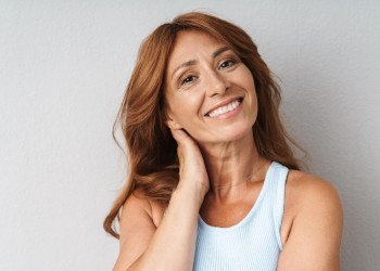 A middle-aged woman wearing dental implants