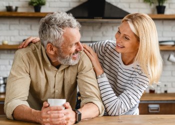 Middle-aged couple smiling in the kitchen