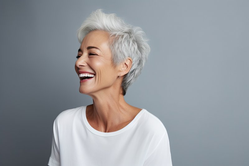 an older woman smiling after cosmetic dentistry